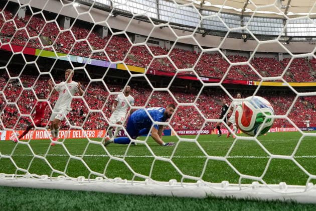 June 24, 2026, Vancouver, Bc, CANADA: Switzerland s Johan Manzambi (9) scores on Canada goalkeeper Maxime Crepeau (16) as Luc de Fougerolles (4) and Derek Cornelius (13) look on during the second half of a World Cup Group B soccer match, in Vancouver, on Wednesday, June 24, 2026. Canada News - June 24, 2026  - ZUMAc35_ 20260624_zaf_c35_172 Copyright: xEthanxCairnsx
