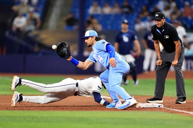 June 24, 2026, St. Petersburg, Florida, USA: Tampa Bay Rays left fielder Chandler Simpson (14) dives back safely before Kansas City Royals first baseman Jac Caglianone (14) can tag him during an MLB, Baseball Herren, USA game on June 24, 2026 at Tropicana Field. The Rays beat the Royals 5-3. MLB 2026: Tampa Bay Rays 5 : 3 Kansas City Royals  - ZUMAh180 20260624_zsp_h180_057 Copyright: xKimxHukarix