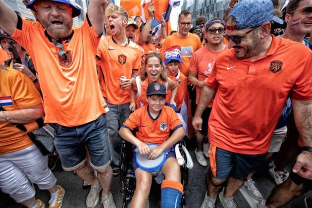 KANSAS CITY, 25-06-2026, Fans In orange tie over de street of Kansas City before the World Cup 2026 Match between Tunesia and The Netherlands. Picture Shows massive crowd following the famous orange painted double decker bus Fans in orange Kansas City  x204640588x Copyright: