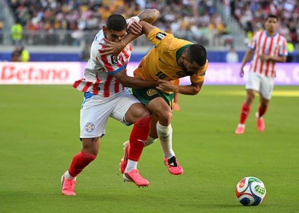 (260626) -- SAN FRANCISCO, June 26, 2026 -- Juan Jose Caceres (L) of Paraguay vies with Aziz Behich of Australia during the group D match between Paraguay and Australia at the 2026 FIFA World Cup, WM, Weltmeisterschaft, Fussball at San Francisco Bay Area Stadium in San Francisco, the United States, June 25, 2026. (Photo by Xinhua) (SP)U.S.-SAN FRANCISCO-FOOTBALL-FIFA WORLD CUP-GROUP D-PRY VS AUS ZiyuxJulianxZhu 