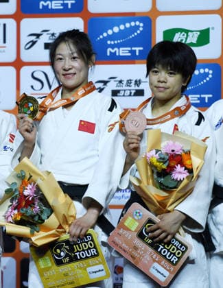 (260626) -- QINGDAO, June 26, 2026 -- Gold medalist Zhuang Wenna (L) of China and bronze medalist Hui Xinran of China pose during the awarding ceremony for the women s -48kg final match at the IJF World Judo Tour Qingdao Grand Prix 2026 in Qingdao, east China s Shandong Province, June 26, 2026. ) (SP)CHINA-QINGDAO-JUDO-GRAND PRIX 2026(CN) LixZiheng 
