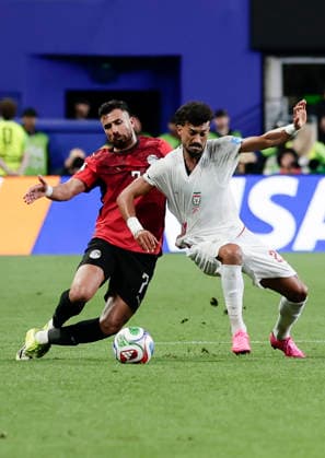 (260627) -- SEATTLE, June 27, 2026 -- Mahmoud Trezeguet (L) of Egypt vies with Ramin Rezaeian of Iran during the group G match between Egypt and Iran at the 2026 FIFA World Cup, WM, Weltmeisterschaft, Fussball at Seattle Stadium in Seattle, the United States, June 26, 2026. (Photo by Xinhua) (SP)U.S.-SEATTLE-FOOTBALL-FIFA WORLD CUP-GROUP G-EGY VS IRN ArthurxDong 