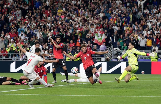 (260627) -- SEATTLE, June 27, 2026 -- Shoja Khalilzadeh (L, front) of Iran shoots during the group G match between Egypt and Iran at the 2026 FIFA World Cup, WM, Weltmeisterschaft, Fussball at Seattle Stadium in Seattle, the United States, June 26, 2026. (Photo by Xinhua) (SP)U.S.-SEATTLE-FOOTBALL-FIFA WORLD CUP-GROUP G-EGY VS IRN ArthurxDong 