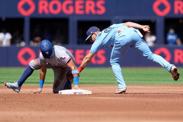 June 27, 2026, Toronto, On, CANADA: Texas Rangers second baseman Nicky Lopez (33) steals second base as Toronto Blue Jays shortstop Andres Gimenez (0) misses the tag during second inning American League MLB, Baseball Herren, USA baseball action in Toronto, Saturday, June 27, 2026. Canada News - June 27, 2026  - ZUMAc35_ 20260627_zaf_c35_064 Copyright: xNathanxDenettex