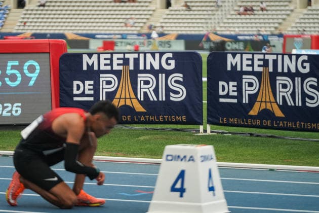 June 28, 2026, Paris, Å½Le-De-France, France: An athlete ties his shoes before competition with Wanda Diamond League branding in the background during the Meeting de Paris at Stade Charlo ty. Paris France - ZUMAh209 20260628_zsp_h209_008 Copyright: xAlixHabibx