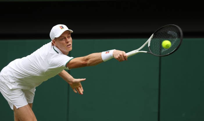 Italy s Jannik Sinner plays a backhand in his match against Serbian Miomir Kecmanovic on day one of the 2026 Wimbledon Championships in London on Monday, June 29, 2026.  LON2026062903 HUGOxPHILPOTT