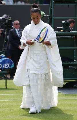 Japan s Naomi Osaka arrives on court before her match against French Elsa Jacquemot on day one of the 2026 Wimbledon Championships in London on Monday, June 29, 2026.  LON2026062927 HUGOxPHILPOTT