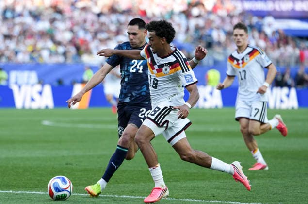 (260630) -- BOSTON, June 30, 2026 -- Nathaniel Brown (front R) vies with Gustavo Caballero (1st L) of Paraguay during the round of 32 match between Germany and Paraguay at the 2026 FIFA World Cup, WM, Weltmeisterschaft, Fussball at Boston Stadium in Boston, the United States, June 29, 2026. ) (SP)U.S.-BOSTON-FOOTBALL-FIFA WORLD CUP-ROUND OF 32-GER VS PRY ChenxYichen 