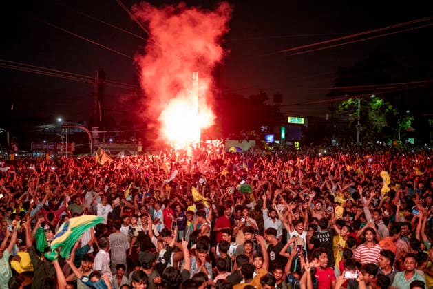 Bangladesh: Football Fans In Chattogram Watch FIFA World Cup, WM, Weltmeisterschaft, Fussball 2026 Match Brazil Vs Japan Fans celebrate at the city intersection with red flares and smoke lighting up the night sky above the gathering in Chattogram, Bangladesh, on June 30, 2026. Thousands of football fans pack Kazir Dewri and 2 No. Gate intersections at midnight to watch the live telecast of the FIFA World Cup match between Brazil and Japan on giant screens. The gathering of Brazil supporters creates a vibrant street festival atmosphere as they cheer for their team. Chattogram Bangladesh  Copyright: xZakirxHossainx originalFilename:hossain-notitle260630_npY7p.jpg