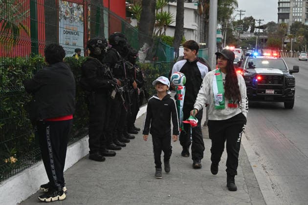 Iranian national team, Nationalteam FIFA World Cup, WM, Weltmeisterschaft, Fussball 2026 leave Tijuana, Mexico camp back home to Iran TIJUANA, MEXICO - JUNE 30: Iran fans walk near members of the Mexican National Guard, as they stand guard, as fans eagerly wait for Iran s national team players to leave the Marriott Hotel at their Tijuana base camp to the airport ahead of the team’s departure following its elimination from the 2026 World Cup football tournament in Tijuana, Mexico on Tuesday, June 30, 2026. Carlos A. Moreno Anadolu Tijuana Mexico. Editorial use only. Please get in touch for any other usage.  Copyright: x2026xAnadoluxCarlosxA.xMorenox