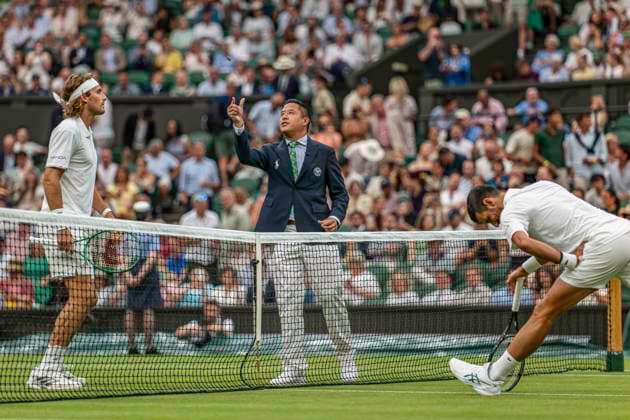RECORD DATE NOT STATED 1st July 2026; All England Lawn Tennis and Croquet Club, London, England; Wimbledon Tennis Tournament, Day Three; Umpire James Keothavong tosses the coin as Stefanos Tsitsipas (GRE) looks on GodfreyxPitt
