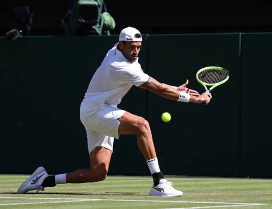 Italian Matteo Berrettini plays a backhand in his match against France s Arthur Fils at Wimbledon on day four of the 2026 Wimbledon Championships in London on Wednesday, July 2, 2026.  LON2026070247 HUGOxPHILPOTT
