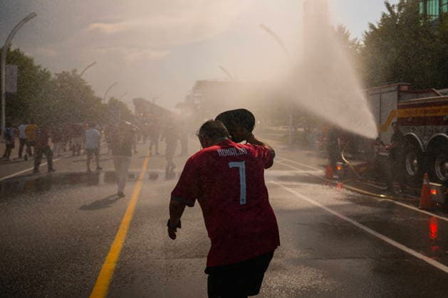 July 2, 2026, Toronto, On, CAN: A Portugal fan runs through a water jet, as fans try and cool off as they arrive for a FIFA 2026 World Cup round of 32 match between Portugal and Croatia in Toronto on Thursday, July 2, 2026. Canada News - July 2, 2026  - ZUMAc35_ 20260702_zaf_c35_055 Copyright: xChrisxYoungx
