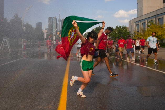 July 2, 2026, Toronto, On, CAN: A Portugal fan runs through a water jet, as fans try and cool off as they arrive for a FIFA 2026 World Cup round of 32 match between Portugal and Croatia in Toronto on Thursday, July 2, 2026. Canada News - July 2, 2026  - ZUMAc35_ 20260702_zaf_c35_056 Copyright: xChrisxYoungx