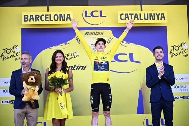 Danish Jonas Vingegaard of Team Visma-Lease a Bike celebrates on the podium in the yellow jersey of leader in the overall ranking after the first stage of the 2026 Tour de France cycling race, a team time trial of 19km with start and finish in Barcelona, Spain, Saturday 04 July 2026. The 113th edition of the Tour de France starts on Saturday 4 July in Barcelona, Spain, and will finish in Paris, France on the 26th of July. JASPERxJACOBS  x180372776x