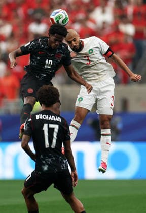 (260705) -- HOUSTON, July 5, 2026 -- Jonathan David (up L) of Canada competes with Noussair Mazraoui of Morocco during the round of 16 match between Canada and Morocco at the 2026 FIFA World Cup, WM, Weltmeisterschaft, Fussball at Houston Stadium in Houston, the United States, July 4, 2026. ) (SP)U.S.-HOUSTON-FOOTBALL-FIFA WORLD CUP-ROUND OF 16-CAN VS MAR LixMing 