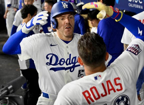 Los Angeles Dodgers first baseman Freddie Freeman celebrates with teammates in the dugout after hitting a solo home run in the sixth inning against the San Diego Padres at Dodger Stadium in Los Angeles on Saturday, July 4, 2026.  LAP2026070405 JIMxRUYMEN