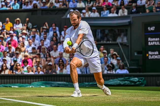 RECORD DATE NOT STATED 5th July 2026; All England Lawn Tennis and Croquet Club, London, England; Wimbledon Tennis Tournament, Day Seven; Roman Safiullin plays a backhand in his forth round match against Novak Djokovic (SRB) GodfreyxPitt