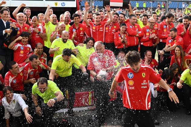 RECORD DATE NOT STATED 5th July 2026; Silverstone Circuit, Northamptonshire, England; FIA Formula 1 2026 British F1 Grand Prix; Race Day; Ferrari team photo after winning first and third place in the British Grand Prix as champagne is sprayed at Charles Leclerc SimonxWest