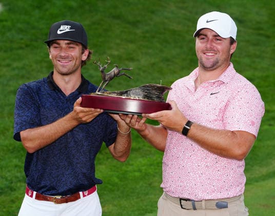 SILVIS, IL - JULY 05: PGA, Golf Herren golfer Chris Gotterup on right poses with his brother Patrick Gotterup his caddie for the tournament and with the trophy after winning the John Deere Classic on July 5, 2026, at TPC Deere Run in Silvis, Illinois. (Photo by Brian Spurlock Icon Sportswire) GOLF: JUL 05 PGA John Deere Classic EDITORIAL USE ONLY Icon26070516