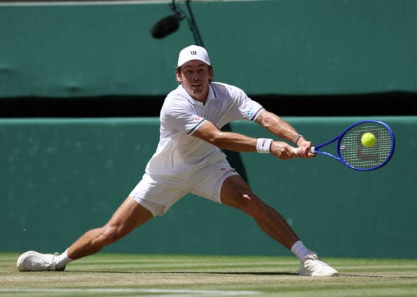 6th July 2026; All England Lawn Tennis and Croquet Club, London, England; Wimbledon Tennis Tournament, Day Eight; Alex De Minar (AUS) with a backhand shot to Flavio Cobolli (ITA) JohnxPatrickxFletcher