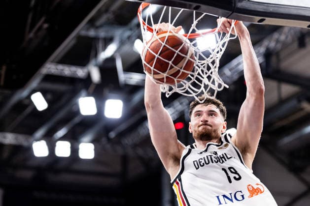 BAMBERG, GERMANY - JULY 06: Kay Bruhnke (Germany, 19) hanging on the basket after a dunk during the FIBA Basketball World Cup European Qualifiers match between Germany vs. Cyprus at Brose Arena on July 06, 2026 in Bamberg, Germany. Bavaria Germany Copyright: xSteffiexWunderlx
