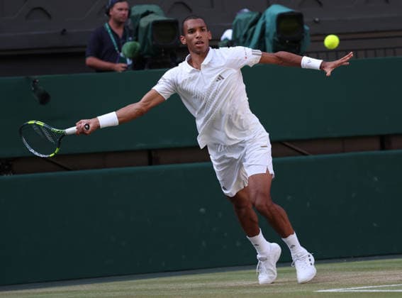 Canada s Felix Auger Aliassime plays a forehand in his Men s Quarter-Finals match against Serbian Novak Djokovic on day nine of the 2026 Wimbledon Championships in London on Tuesday, July 07, 2026.  LON2026070796 HUGOxPHILPOTT