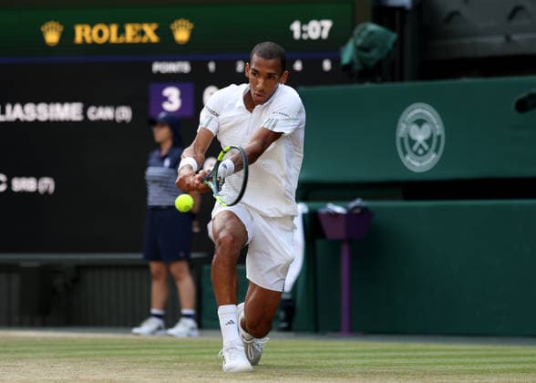RECORD DATE NOT STATED 7th July 2026; All England Lawn Tennis and Croquet Club, London, England; Wimbledon Tennis Tournament, Day Nine; Feliz Auger-Aliassime (CAN) with a backhand shot to Novak Djokovic (SRB) JohnxPatrickxFletcher