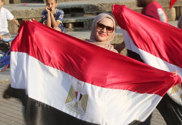 July 7, 2026, Nablus, Palestine: A Palestinian lady holds an Egyptian flag while watching the World Cup match between Egypt and Argentina. Palestinian fans seen at Jamal Abdel Nasser Stadium, watching the match via live World Cup broadcast big screen tv. Final scores; Argentina 3 : 2 Egypt. Egypt Vs Argentina In Nablus, Palestine - 07 Jul 2026  - ZUMAs197 20260707_aaa_s197_055 Copyright: xNasserxIshtayehx