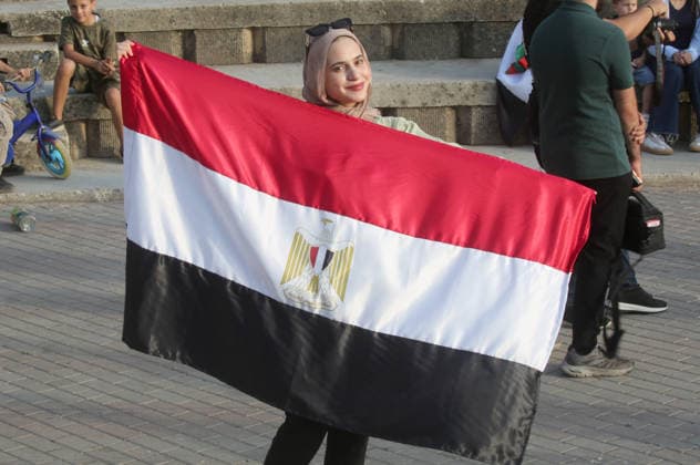 July 7, 2026, Nablus, Palestine: A Palestinian girl holds an Egyptian flag while watching the World Cup match between Egypt and Argentina. Palestinian fans seen at Jamal Abdel Nasser Stadium, watching the match via live World Cup broadcast big screen tv. Final scores; Argentina 3 : 2 Egypt. Egypt Vs Argentina In Nablus, Palestine - 07 Jul 2026  - ZUMAs197 20260707_aaa_s197_056 Copyright: xNasserxIshtayehx