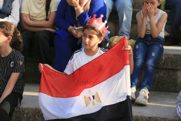 July 7, 2026, Nablus, Palestine: A Palestinian kid holds an Egyptian flag while watching the World Cup match between Egypt and Argentina. Palestinian fans seen at Jamal Abdel Nasser Stadium, watching the match via live World Cup broadcast big screen tv. Final scores; Argentina 3 : 2 Egypt. Egypt Vs Argentina In Nablus, Palestine - 07 Jul 2026  - ZUMAs197 20260707_aaa_s197_057 Copyright: xNasserxIshtayehx