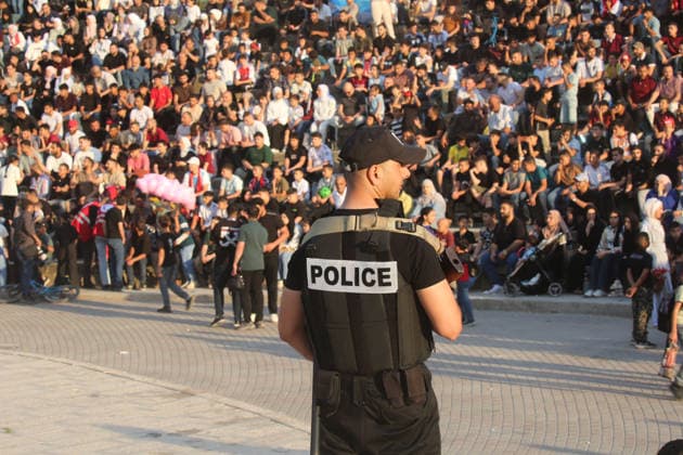 July 7, 2026, Nablus, Palestine: A Palestinian policeman stands on guard while fans watch the World Cup match between Egypt and Argentina. Palestinian fans seen at Jamal Abdel Nasser Stadium, watching the match via live World Cup broadcast big screen tv. Final scores; Argentina 3 : 2 Egypt. Egypt Vs Argentina In Nablus, Palestine - 07 Jul 2026  - ZUMAs197 20260707_aaa_s197_060 Copyright: xNasserxIshtayehx