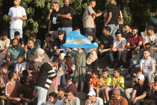July 7, 2026, Nablus, Palestine: A Palestinian waves an Argentinian flag while watching the World Cup match between Egypt and Argentina. Palestinian fans seen at Jamal Abdel Nasser Stadium, watching the match via live World Cup broadcast big screen tv. Final scores; Argentina 3 : 2 Egypt. Egypt Vs Argentina In Nablus, Palestine - 07 Jul 2026  - ZUMAs197 20260707_aaa_s197_063 Copyright: xNasserxIshtayehx