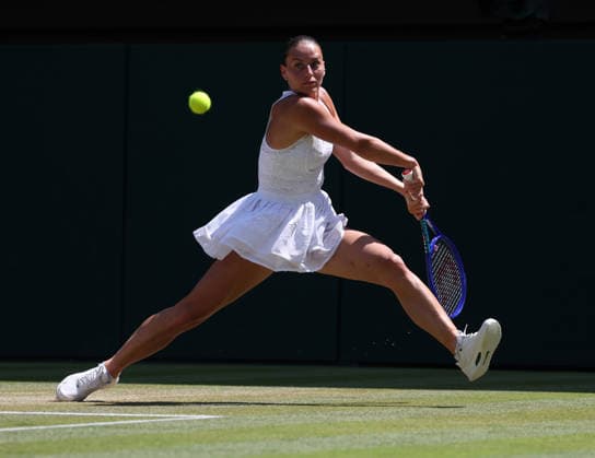 Ukraine s Marta Kostyuk plays a backhand in her Women s Quarter-Finals match against Italy s Jasmine Paolini on day Ten of the 2026 Wimbledon Championships in London on Wednesday, July 08,2026.  LON2026070809 HUGOxPHILPOTT
