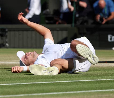 Great Britain s Arthur Fery falls over after victory in his Men s Quarter-Finals match against Italy s Flavio Cobolli on day Ten of the 2026 Wimbledon Championships in London on Wednesday, July 08,2026.  LON2026070852 HUGOxPHILPOTT