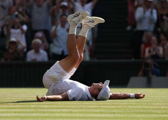 RECORD DATE NOT STATED 8th July 2026; All England Lawn Tennis and Croquet Club, London, England; Wimbledon Tennis Tournament, Day Ten; Arthur Fery (GBR) falls onto the court in celebration following victory over Flavio Cobolli (ITA) to reach the Gentlemens Semi Final for the first time as a wild card JohnxPatrickxFletcher