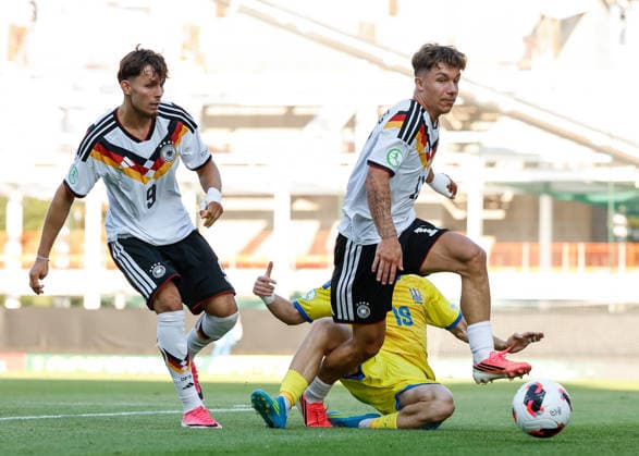 Wrexham, Wales, 8th July 2026. Vitaliy Hlyut of Ukraine tackles Moritz Reimers of Germany during the Ukraine U19 vs Germany U19 UEFA European U19 Championship match at The Racecourse, Wrexham. Picture credit should read: Cody Froggatt Sportimage EDITORIAL USE ONLY. No use with unauthorised audio, video, data, fixture lists, club league logos or live services. Online in-match use limited to 120 images, no video emulation. No use in betting, games or single club league player publications. SPI_025_CF_UKRAINE_U19_V_GERMANY_U19 SPI-4857-0024
