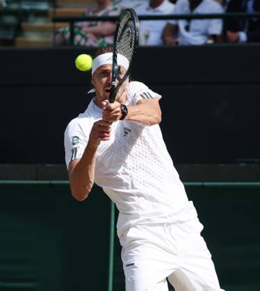Germany s Alexander Zverev plays a backhand in his Men s Quarter-Finals match against American Taylor Fritz on day Ten of the 2026 Wimbledon Championships in London on Wednesday, July 08,2026. Zverev won the match 6-4 6-4 6-2.  LON2026070892 HUGOxPHILPOTT
