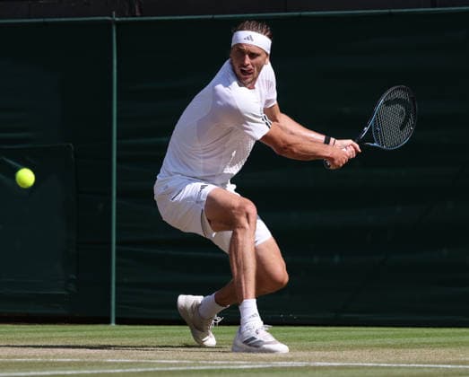 Germany s Alexander Zverev plays a backhand in his Men s Quarter-Finals match against American Taylor Fritz on day Ten of the 2026 Wimbledon Championships in London on Wednesday, July 08,2026. Zverev won the match 6-4 6-4 6-2.  LON2026070894 HUGOxPHILPOTT