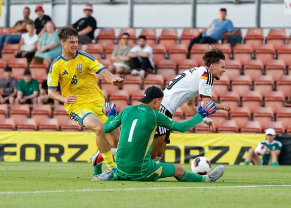 Wrexham, Wales, 8th July 2026. Nazar Domchak of Ukraine tackles Otto Stange of Germany during the Ukraine U19 vs Germany U19 UEFA European U19 Championship match at The Racecourse, Wrexham. Picture credit should read: Cody Froggatt Sportimage EDITORIAL USE ONLY. No use with unauthorised audio, video, data, fixture lists, club league logos or live services. Online in-match use limited to 120 images, no video emulation. No use in betting, games or single club league player publications. SPI_031_CF_UKRAINE_U19_V_GERMANY_U19 SPI-4857-0030