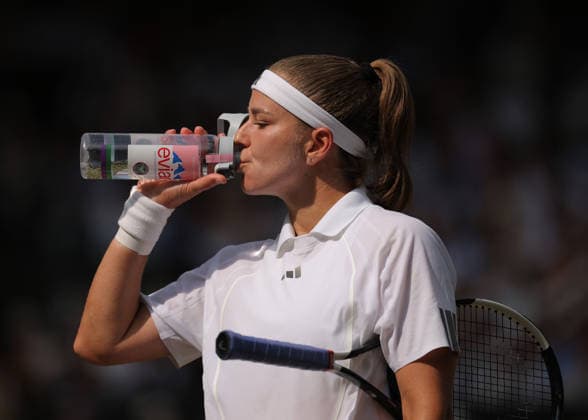 RECORD DATE NOT STATED 9th July 2026; All England Lawn Tennis and Croquet Club, London, England; Wimbledon Tennis Tournament, Day Eleven; Karolina Muchova (CZE) drinking a bottle of water during the break to keep hydrated under the hot weather in her semi final match against Coco Gauff (USA) JohnxPatrickxFletcher