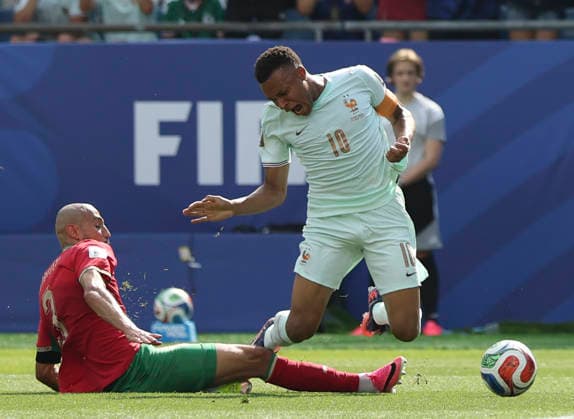 (260710) -- BOSTON, July 10, 2026 -- Kylian Mbappe (R) of France is fouled by Noussair Mazraoui of Morocco during the quarter final match between France and Morocco at the 2026 FIFA World Cup, WM, Weltmeisterschaft, Fussball at Boston Stadium in Boston, the United States, July 9, 2026. ) (SP)U.S.-BOSTON-FOOTBALL-FIFA WORLD CUP-QUARTER FINAL-FRA VS MAR ZhangxChen 