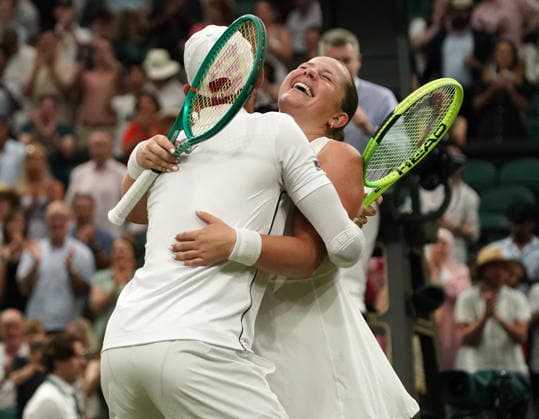 Tennis - 2026 Wimbledon Championships - Day Eleven (Week Two) - All England Lawn Tennis & Croquet Club, London - Thursday 8th July 2026 Centre Court : Mixed Doubles Final : Marc Polmans and Storm Hunter (AUS) v Marcelo Arevalo (ESA) and Jelena Ostapenko (LAT) Marcelo Arevalo (ESA) and Jelena Ostapenko (LAT) embrace as they celebrate winning match point COLORSPORT ANDREW COWIE 