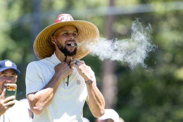 STATELINE, NV - JULY 09: Stephen Curry blows smoke from a cigar wearing a sombrero on the 18th hole during the preview round of the American Century Championship on July 9, 2026 at Edgewood Tahoe Golf Course in Stateline, NV. (Photo by Matthew Huang Icon Sportswire) GOLF: JUL 09 American Century Championship EDITORIAL USE ONLY Icon260709076