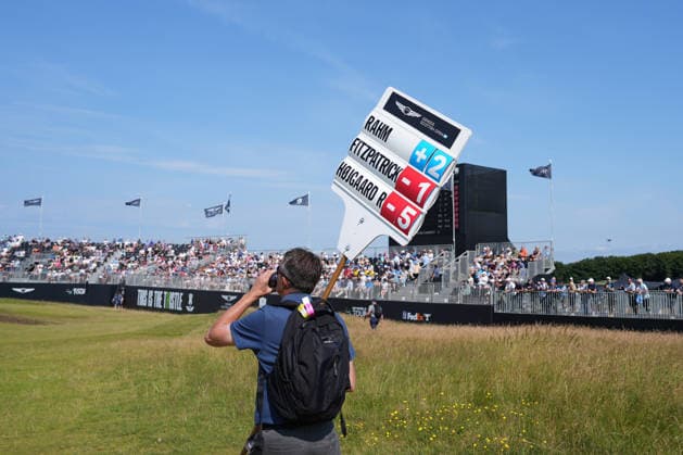 RECORD DATE NOT STATED 10th July 2026; The Renaissance Club, North Berwick, East Lothian, Scotland: Genesis Scottish Open Golf, Day Two; a Marshall carries the scoreboard for Jon Rahm, Alex Fitzpatrick and Nicolai Hojgaard at the thistle hole 15th during the second round of the Genesis Scottish Open AlecxBrown