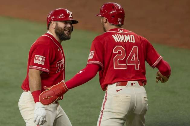 July 10, 2026, Arlington, Texas, USA: Texas Rangers right fielder BRANDON NIMMO (24) congratulates Texas Rangers first baseman JAKE BURGER (21) on a three run home run during a MLB, Baseball Herren, USA game between the Houston Astros and Texas Rangers at Globe Life Field. Rangers win 7-3. Arlington USA - ZUMAf180 20260710_zsp_f180_007 Copyright: xMarkxFannx