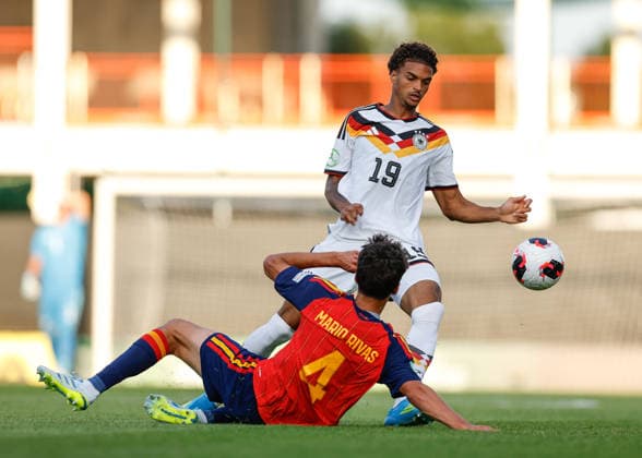 Wrexham, Wales, 11th July 2026. Mario Rivas of Spain tackles Jykese Fields of Germany during the Spain U19 vs Germany U19 UEFA European U19 Championship Final match at The Racecourse, Wrexham. Picture credit should read: Cody Froggatt Sportimage EDITORIAL USE ONLY. No use with unauthorised audio, video, data, fixture lists, club league logos or live services. Online in-match use limited to 120 images, no video emulation. No use in betting, games or single club league player publications. SPI_040_CF_SPAIN_U19_V_GERMANY_U19_FINAL SPI-4858-0040