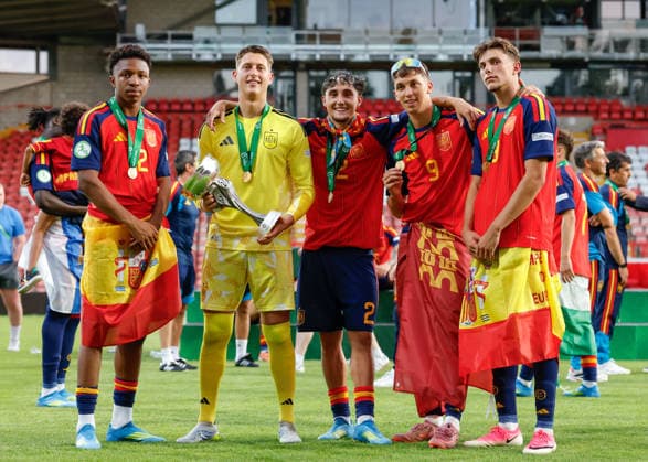 Wrexham, Wales, 11th July 2026. Left to right Aboubacar Sangare, Pau Polo, Jesus Fortea, Hugo Lopez and Sergio Esteban of Spain pose with the UEFA European U19 Championship trophy following the Spain U19 vs Germany U19 UEFA European U19 Championship Final match at The Racecourse, Wrexham. Picture credit should read: Cody Froggatt Sportimage EDITORIAL USE ONLY. No use with unauthorised audio, video, data, fixture lists, club league logos or live services. Online in-match use limited to 120 images, no video emulation. No use in betting, games or single club league player publications. SPI_096_CF_SPAIN_U19_V_GERMANY_U19_FINAL SPI-4858-0096