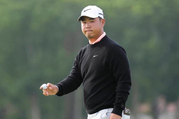 NORTH BERWICK, SCOTLAND - JULY 12: Tom Kim acknowledges the fans after holing a birdie putt on the 11th green during the delayed Round 3 of the Genesis Scottish Open at the Renaissance Club, North Berwick on July 12, 2026 in North Berwick, Scotland Genesis Scottish Open Round 3