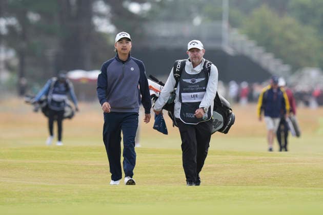 NORTH BERWICK, SCOTLAND - JULY 12: Min Woo Lee and his caddie Shane Joel walk up the 14th hole during the delayed Round 3 of the Genesis Scottish Open at the Renaissance Club, North Berwick on July 12, 2026 in North Berwick, Scotland Genesis Scottish Open Round 3